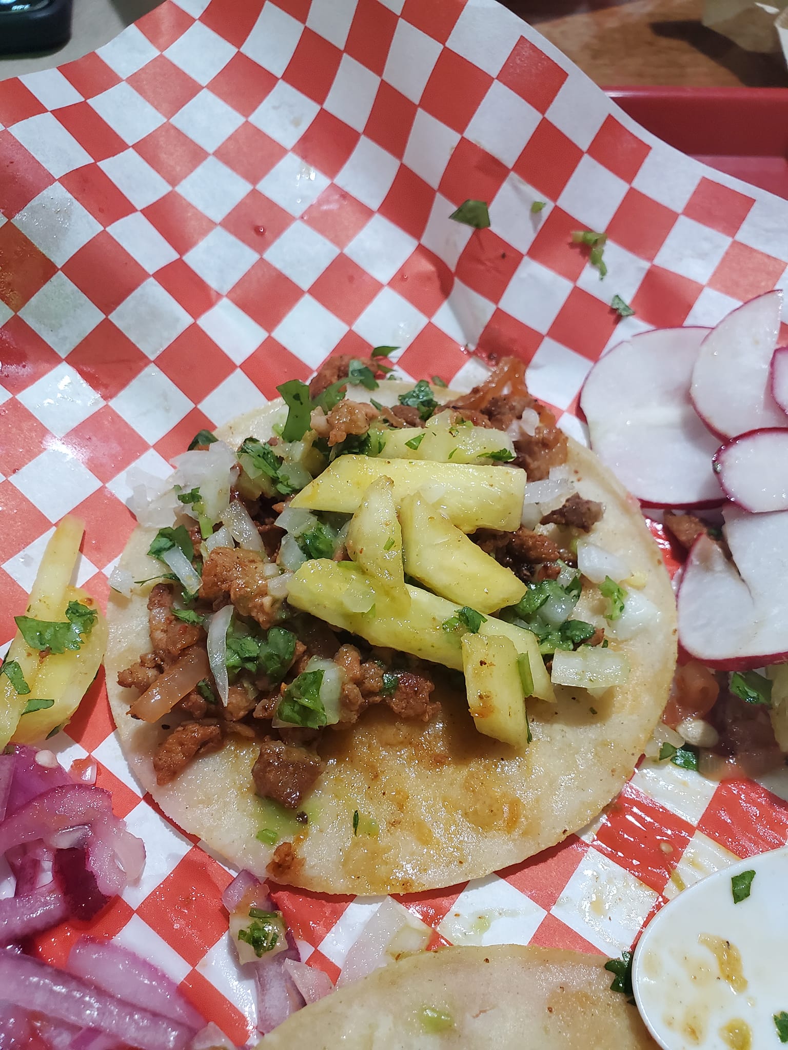 Chorizo taco with pineapple, pickled onion, and radish